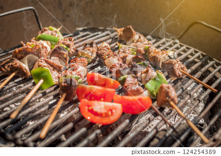 Roast beef skewers on a grill, Roast beef skewers grilling on a grill, Roast beef concept 124254389