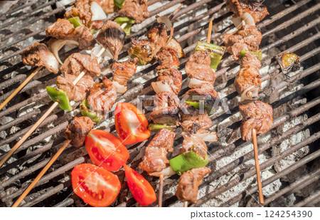 Roast beef skewers on a grill, Roast beef skewers grilling on a grill, Roast beef concept 124254390