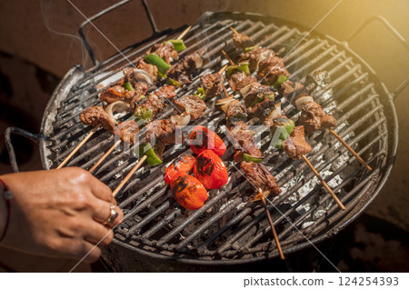 Roast beef skewers on a grill, Roast beef skewers grilling on a grill, Roast beef concept 124254393