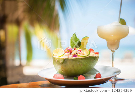 Nicaraguan food of a coconut with ceviche and fruit drink 124254399