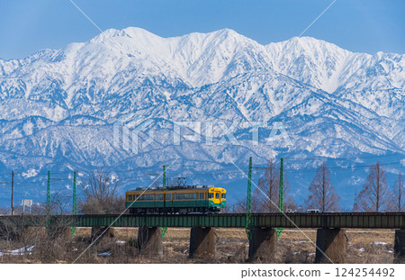 Toyama Chiho Railway and the snowy Tateyama mountain range Toyama Chiho Railway and the snowy Tateyama mountain range 124254492