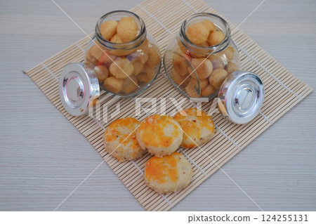two small glass jars filled with golden brown bite sized cookies two small glass jars filled with golden brown bite sized cookies 124255131