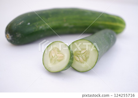 Cucumber and slices on a white background. Selective focus. Cucumber and slices on a white background. Selective focus. 124255716