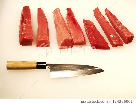 Freshly Sliced Tuna Sashimi with a Japanese Knife. 124256001