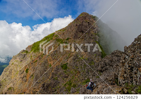 Cloud-filled Yatsugatake mountain range and Akadake peak seen from Ryuzu Peak Cloud-filled Yatsugatake mountain range and Akadake peak seen from Ryuzu Peak 124256829