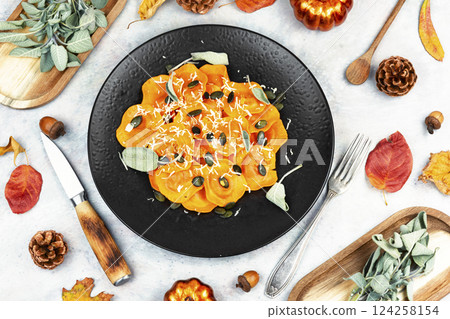 Plate of pumpkin ravioli with sage leaves. Plate of pumpkin ravioli with sage leaves. 124258154
