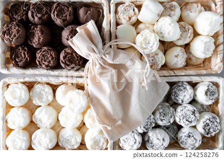 Assorted solid aroma oil in the form of peonies in wooden baskets with linen bag 124258276