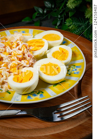 Breakfast. Hard-boiled eggs with ham, pineapple and corn salad. Breakfast. Hard-boiled eggs with ham, pineapple and corn salad. 124258407