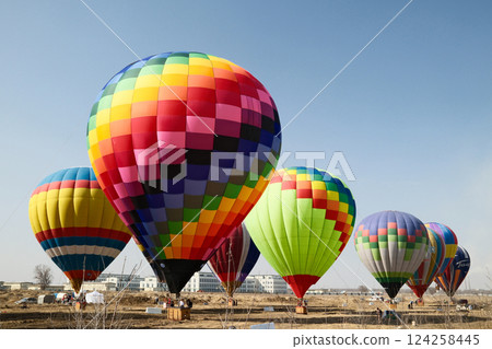 Colorful hot air balloons taking flight on a sunny day Colorful hot air balloons taking flight on a sunny day 124258445