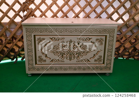 Ornate Kazakh wooden chest with intricate carvings 124258468