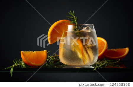 Hard seltzer with ice, orange, and rosemary. 124258598