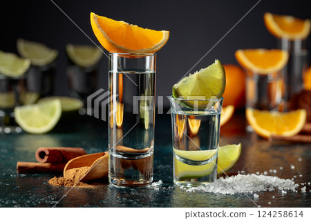 Tequila shots on a black background. Tequila shots on a black background. 124258614