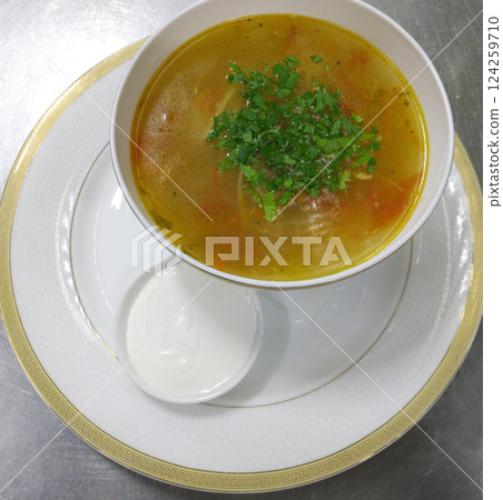 chicken broth or soup with vegetables and quail meat in a round plate, top view chicken broth or soup with vegetables and quail meat in a round plate, top view 124259710