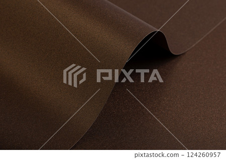 Warm brown paper background with a smooth, grainy texture and metallic bronze shimmer. A subtle 124260957