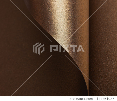 Elegant gold and bronze paper background with a glossy, pearlescent texture. Shimmering metallic 124261027