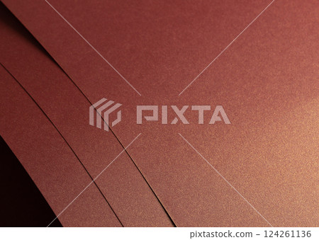 Burgundy paper background with a glossy, pearlescent texture and shimmering metallic finish. Warm, 124261136