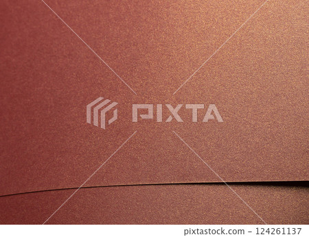 Burgundy paper background with a glossy, pearlescent texture and shimmering metallic finish. Rich, 124261137