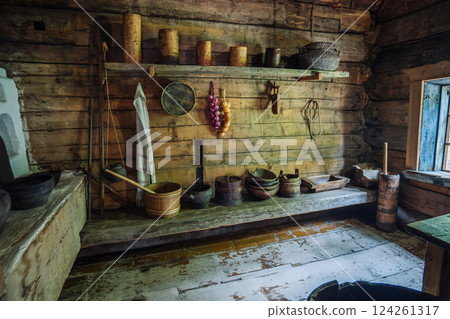 Ancient wooden kitchen in a rural house in russia, displaying traditional tools and utensils, evoking a historical lifestyle Ancient wooden kitchen in a rural house in russia, displaying traditional tools and utensils, evoking a historical lifestyle 124261317