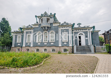 Traditional wooden dwelling featuring colorful floral landscaping near historic siberian street in irkutsk Traditional wooden dwelling featuring colorful floral landscaping near historic siberian street in irkutsk 124261333