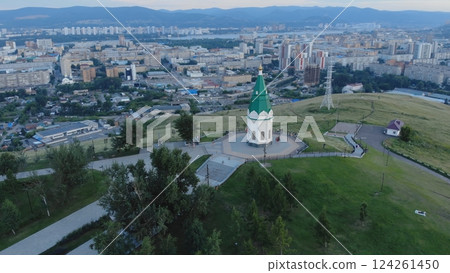 Aerial view of paraskeva pyatnitsa chapel on karaulnaya hill, providing a scenic overlook of krasnoyarsk city during sunset Aerial view of paraskeva pyatnitsa chapel on karaulnaya hill, providing a scenic overlook of krasnoyarsk city during sunset 124261450