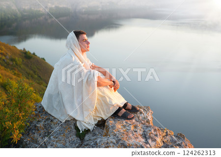 Young man sitting on the rock 124262313
