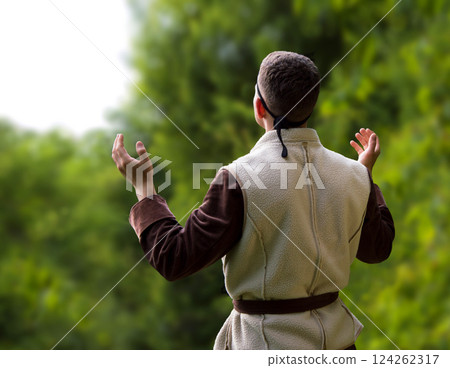 Praying man with raised hands Praying man with raised hands 124262317