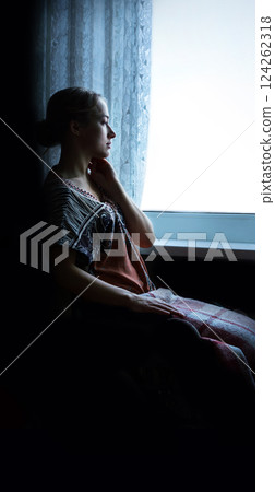 Disabled person in stroller by window 124262318