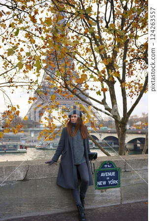 Parisian Woman in Beret Poses Against the Eiffel Tower and Avenue De New York Parisian Woman in Beret Poses Against the Eiffel Tower and Avenue De New York 124263557