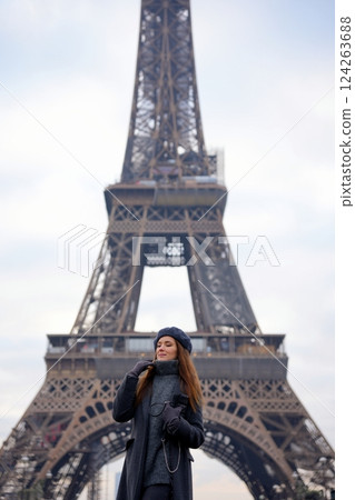 Parisian Woman in Beret and Grey Coat Poses on Highway with Eiffel Tower Parisian Woman in Beret and Grey Coat Poses on Highway with Eiffel Tower 124263688