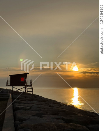 Lifeguard Hut Overlooking Ocean at Golden Sunset Lifeguard Hut Overlooking Ocean at Golden Sunset 124264162