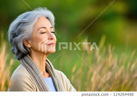 Elderly Woman Finding Peace Through Meditation in Nature Elderly Woman Finding Peace Through Meditation in Nature 124264486