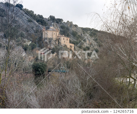 Historic Monastery Nestled in Rocky Hillside Landscape 124265716