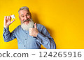 Happy elderly man with a tooth in his hand 124265916