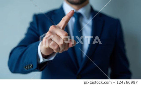 businessman pointing index finger forward indicating selection or decision making, formal blue suit, concept of leadership and authority businessman pointing index finger forward indicating selection or decision making, formal blue suit, concept of leadership and authority 124266987