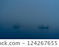 Fishing boats moored in harbor in heavy fog 124267655