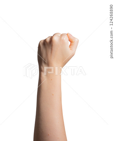 Fist raised, symbol of power and victory. Female hand in clenched position, showing strength and Fist raised, symbol of power and victory. Female hand in clenched position, showing strength and 124268890
