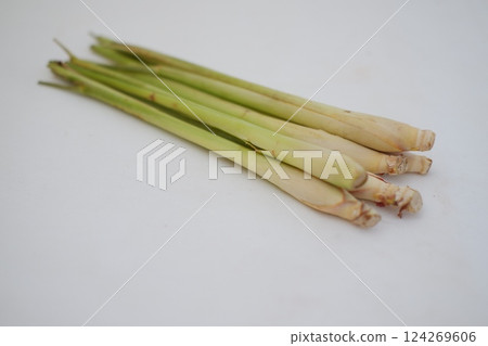 fresh lemongrass stalks placed on a white surface fresh lemongrass stalks placed on a white surface 124269606