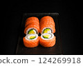 Delicious Fresh Salmon Sushi Rolls Presenting Exquisitely on a Black Background 124269918