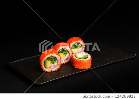 Delicious Fresh Salmon Sushi Rolls Presenting Exquisitely on a Black Background 124269922