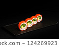 Delicious Fresh Salmon Sushi Rolls Presenting Exquisitely on a Black Background 124269923