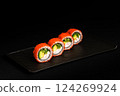 Delicious Fresh Salmon Sushi Rolls Presenting Exquisitely on a Black Background 124269924