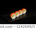 Delicious Fresh Salmon Sushi Rolls Presenting Exquisitely on a Black Background 124269925