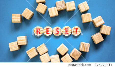 Reset symbol. Concept word Reset on beautiful wooden circles. Beautiful blue table blue background. Beautiful wooden cubes. Business lifestyle reset concept. Copy space. 124270214