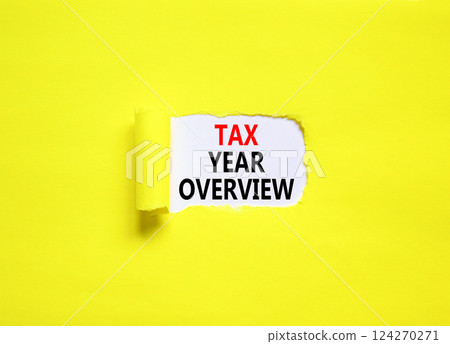 Tax year overview symbol. Concept words Tax year overview on beautiful white paper. Beautiful yellow table yellow background. Business tax year overview concept. Copy space. Tax year overview symbol. Concept words Tax year overview on beautiful white paper. Beautiful yellow table yellow background. Business tax year overview concept. Copy space. 124270271