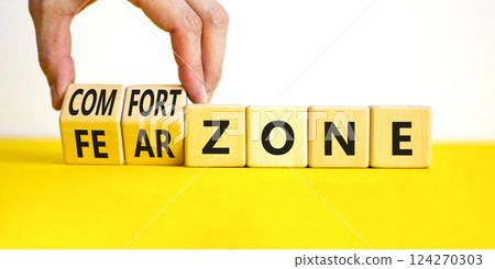Comfort or fear zone symbol. Concept words Comfort zone Fear zone on wooden cubes. Beautiful yellow table white background. Psychologist hand. Business and comfort or fear zone concept. Copy space. Comfort or fear zone symbol. Concept words Comfort zone Fear zone on wooden cubes. Beautiful yellow table white background. Psychologist hand. Business and comfort or fear zone concept. Copy space. 124270303