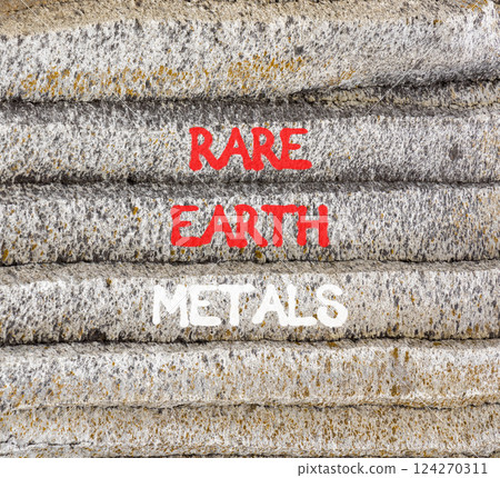 Rare earth metals symbol. Concept words Rare earth metals on beautiful grey stone wall. Beautiful grey mountain stone wall background. Business and rare earth metals concept. Copy space. 124270311