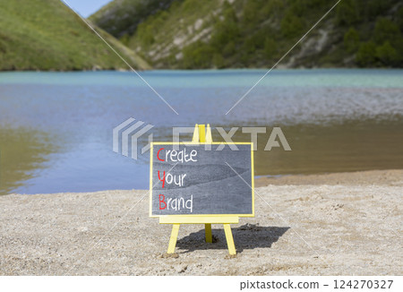 CYB Create your brand symbol. Concept words CYB Create your brand on beautiful yellow blackboard. Beautiful mountain lake background. Business CYB Create your brand concept. Copy space. 124270327