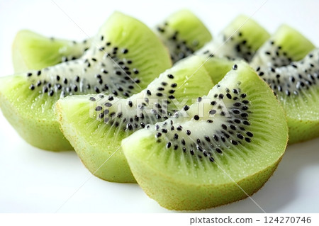 Sliced kiwi fruit showing seeds and flesh on white background Sliced kiwi fruit showing seeds and flesh on white background 124270746
