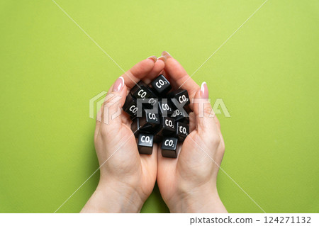 CO2 cubes in hands. Personal carbon footprint. Individual carbon emissions. Environmental impact. Climate change awareness, air pollution concerns. Eco-conscious habits. Environmental responsibility CO2 cubes in hands. Personal carbon footprint. Individual carbon emissions. Environmental impact. Climate change awareness, air pollution concerns. Eco-conscious habits. Environmental responsibility 124271132