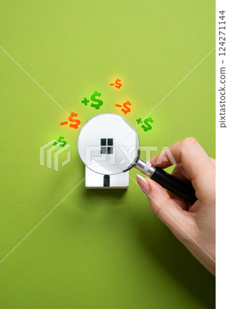 Studying a house under a magnifying glass. Property valuation before purchase. What will bring profit and what will require expenses for repairs and additional purchases. Real estate assessment 124271144